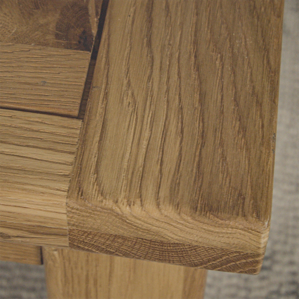 A close up of the top of the Amstel Square Oak Coffee Table, showing the wood grain.