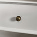 A close up of the brushed brass metal handle on the drawers/doors on the Biarritz Two-piece Wardrobe.