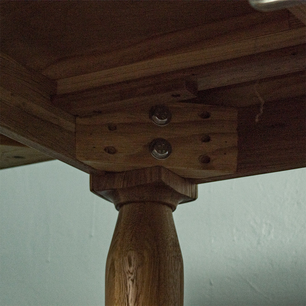 A view of the bolts that hold the legs to the Boston Oak Extending Dining Table - Natural Oak.