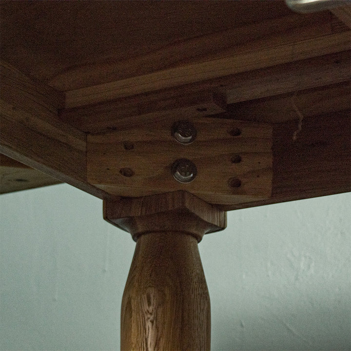A view of the bolts that hold the legs to the Boston Oak Extending Dining Table - Natural Oak.