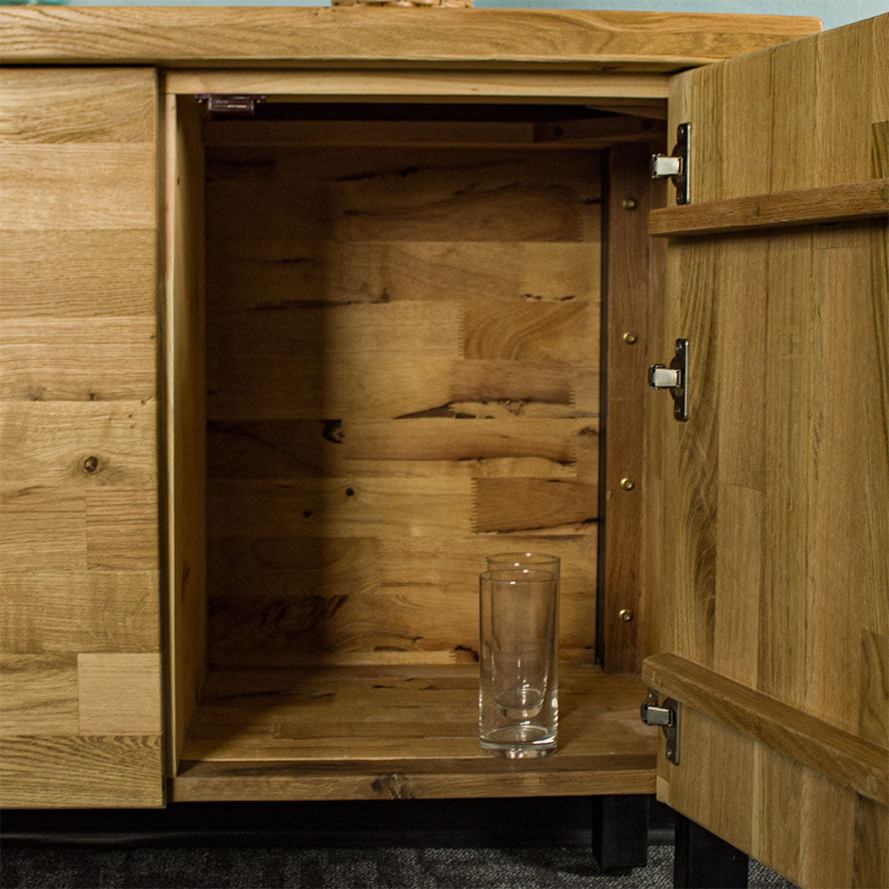 An overall view of the smaller side shelf on the Golden Gate Three Door Oak Buffet