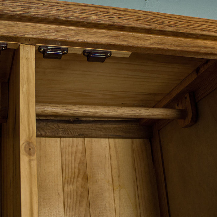 A close up of the coat rail and door magnets at the top of the Vienna Oak Large Wardrobe.