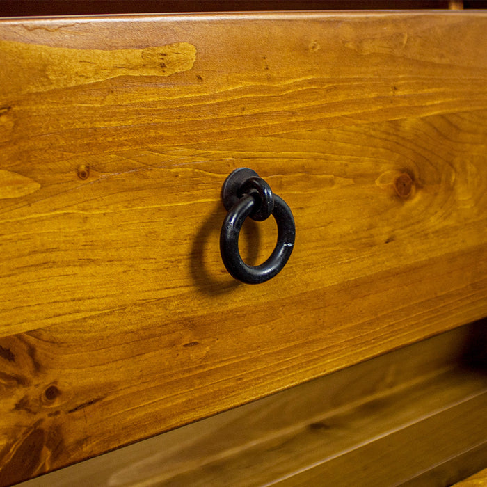 A close up of the brushed brass metal handle on the drawers/doors on the Biarritz Two-piece Wardrobe.