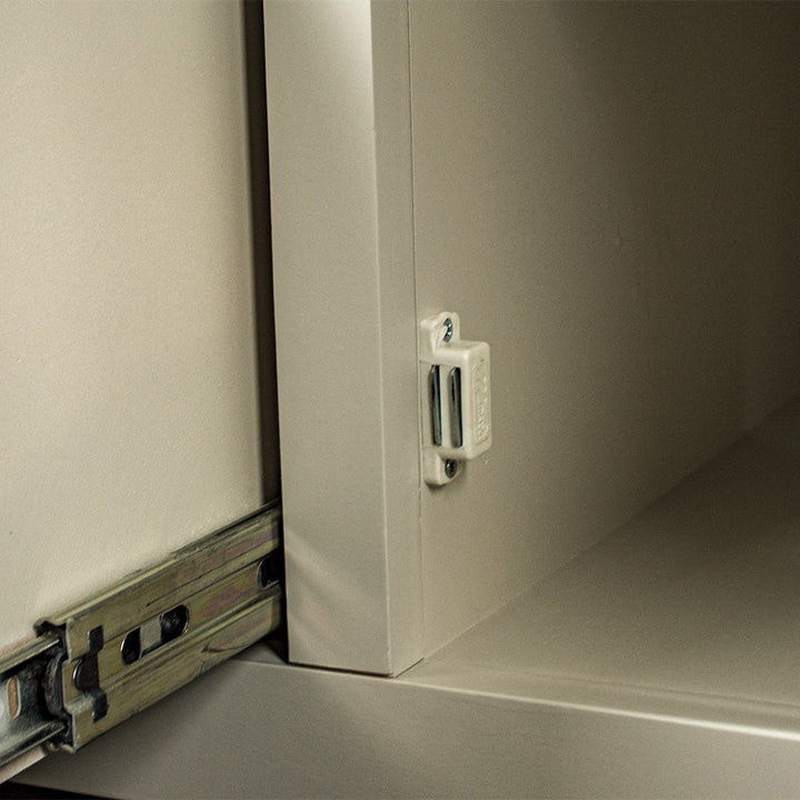 Close up of the metal magnet for the door catch on the white Alton 2 Door 5 Drawer Buffet