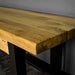 A close up of the top of the Golden Gate Long Oak Bench, showing the wood grain and colour.