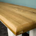 A close up of the top of the Loire Solid Oak Bench Seat (White), showing the wood grain and colour.