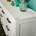 A close up of the top of the Vancouver 7 Drawer White Lowboy, showing the wood grain.