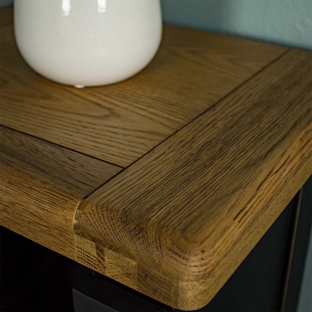 A close up of the top of the Cascais Small Black Cupboard, showing the wood grain and colour.