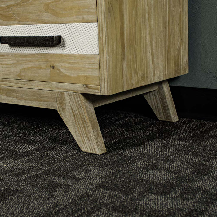 A close up of the legs on the Soho 5 Drawer Tallboy.