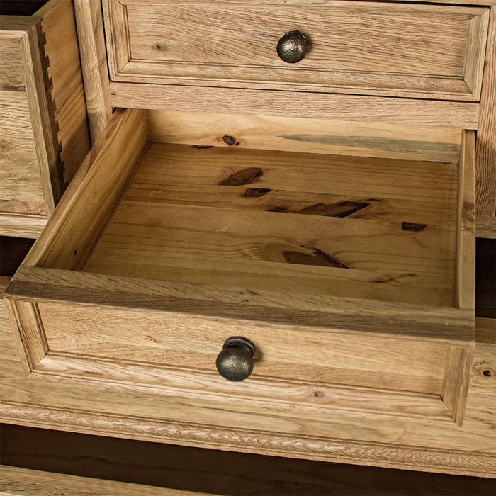 An overall view of the smaller middle drawer on the Versailles Oak 7 Drawer Chest.
