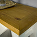 A close up of the top of the Felixstowe Large Pine Hall Table, showing the wood grain and colour.