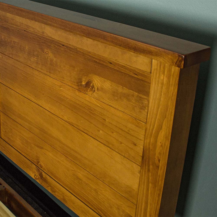 A close view of the side of the headboard on the Alton Rimu-Stained NZ Pine King Bed Frame.