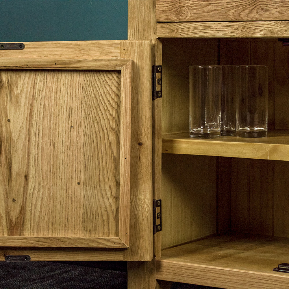 A close up of the hinges on the door of the Maximus Small Oak Buffet