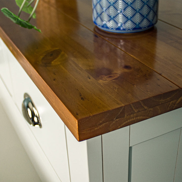 A close up of the top of the Alton 6 Drawer NZ Pine Tallboy, showing the rimu stain and wood grain.