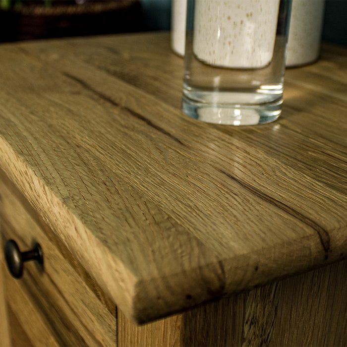 A close up of the top of the Beethoven Oak Bedside Table with 3 Drawers, showing the wood grain.