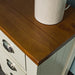 The Rimu stained top of the Alton 3 Drawer Pine Bedside Cabinet