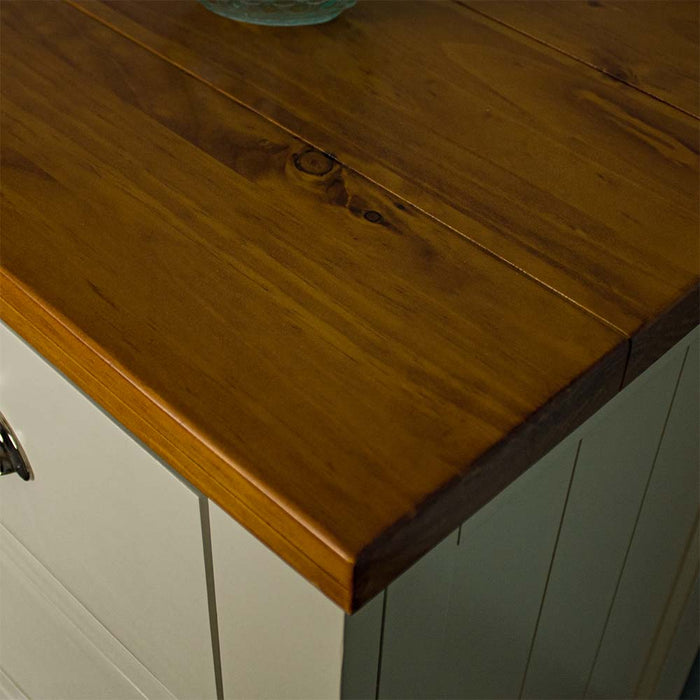 A close up of the top of the Alton 7 Drawer Pine Lowboy, showing the wood grain and colour.