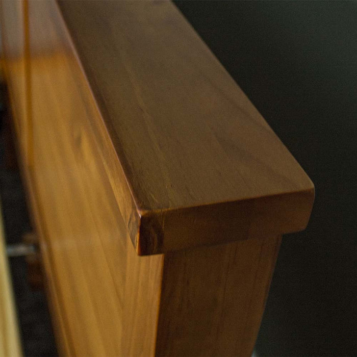 A close up of the top of the Alton Rimu-Stained NZ Pine King Bed Frame, showing the rimu stain and wood grain.