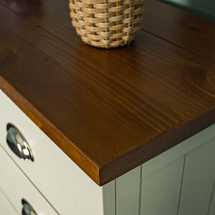 A close up of the top of the Alton 6 Drawer NZ Pine Tallboy, showing the rimu stain and wood grain.