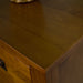 A close up of the top of the Montreal Five Drawer Pine Tallboy showing the wood grain.