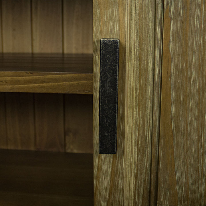A close up of the brushed black metal handle on the door of the Vancouver Pine Buffet.