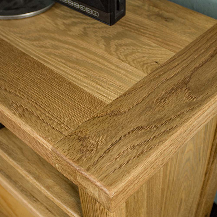 A close up of the top of the Vancouver Value Oak Entertainment Unit, showing the wood grain and colour.