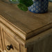 A close up of the top of the Versailles Oak 7 Drawer Chest, showing the wood grain.