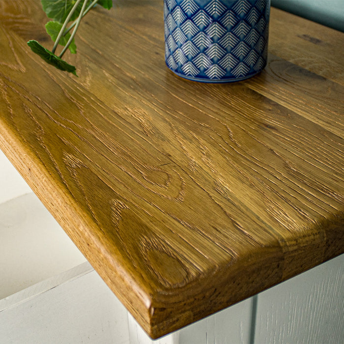 A close up of the top of the Loire Two-Tone Medium Oak Buffet, showing the wood grain and colour.