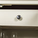 Close up of the chrome metal doorknob style handle on the white Alton 2 Door 5 Drawer Buffet