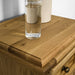 The top of the Versailles Oak Bedside Cabinet, showing the wood grain.
