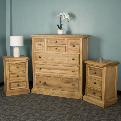 The Versailles 3 Piece Bedroom Suite. There are two Versailles Oak Bedside Cabinets on either side of the Versailles Oak 7 Drawer Chest.
