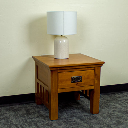 The front of the Montreal Pine Lamp Table, with a lamp on top.