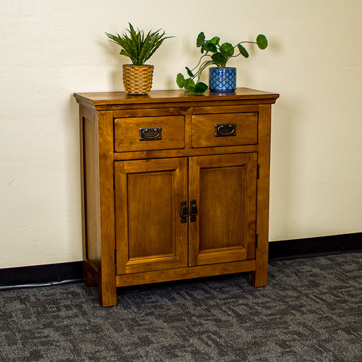 The front of the Montreal Small Pine Buffet. There are two potted plants on top.