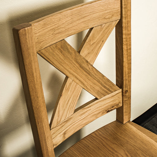 A close up of the cross pattern brace on the back support of the Maximus Oak Dining Chair