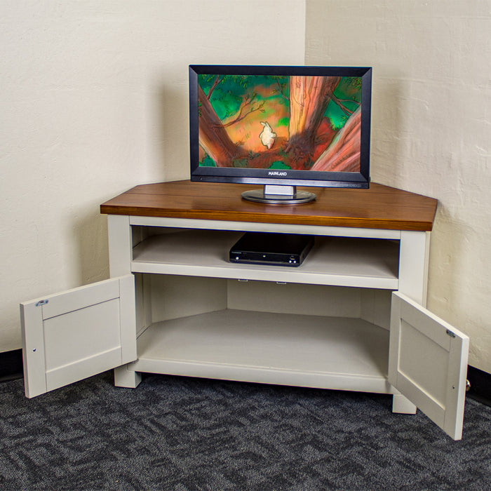 The Alton Corner TV Unit with its doors open. There is a small TV on top and a DVD player in the shelf.