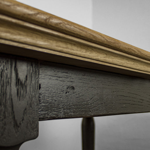 A close up of the side of the Boston Oak Dining Table, showing the colour and wood grain.