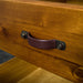 A close up of the pleather and brushed black metal handle on the drawers of the Jamaica Bedside Cabinet.