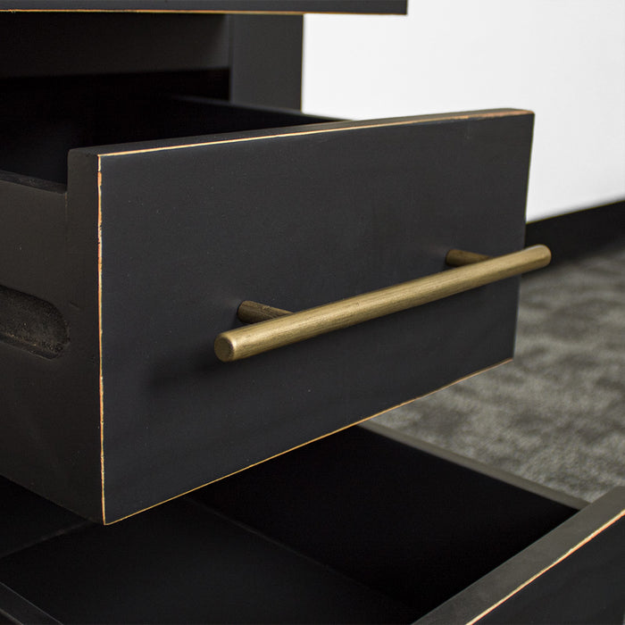 A close up of the gold coloured metal handle on the drawers of the Cascais 3 Drawer Black Bedside Table.