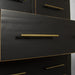 A close up of the gold coloured metal handle on the Cascais Oak Top Black Tallboy