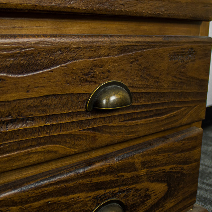 A close up of the circular brushed brass colour handles on the drawers of the Heid Large 3 Drawer Pine Bedside.