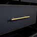 A close up of the gold coloured metal handle on the Cascais Oak Top 7 Drawer Lowboy (Black).