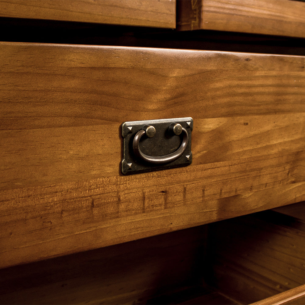 A close up of the brushed black metal handle on the drawers of the New Quebec 7 Drawer Lowboy.