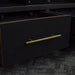 A close up of the gold coloured metal handle on the Cascais Oak-top Corner Entertainment Unit.