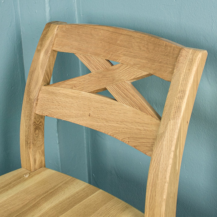 The back support of the Maximus Oak High Bar Stool