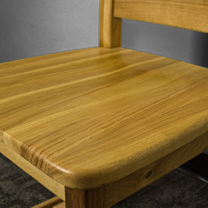 A close up of the top of the seat on the Loire Solid American Oak Dining Chair.