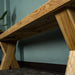 A view of under the Maximus Oak Cross Leg Bench Seat (1.9m).