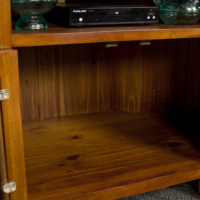 A closer view of the larger cavity below the shelf on the Montreal Pine Corner Entertainment Unit.