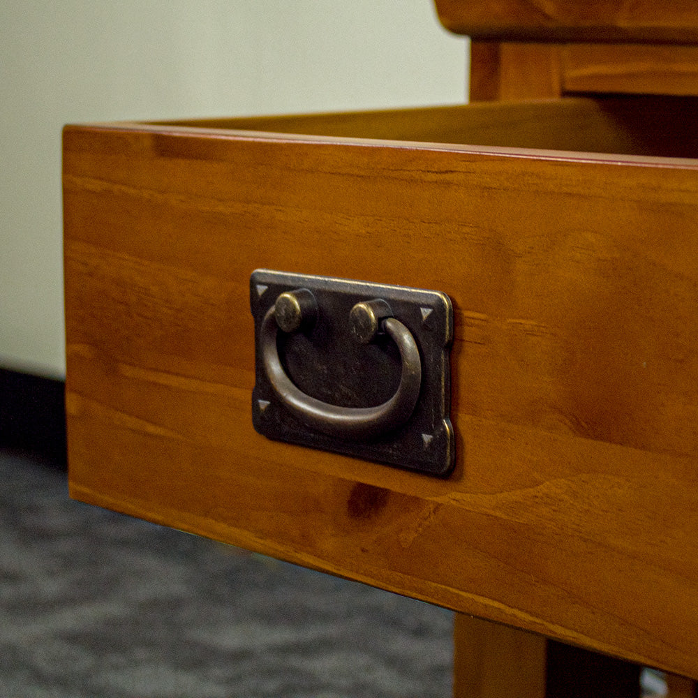 A close up of the handle on the drawer of the Montreal Pine Lamp Table.