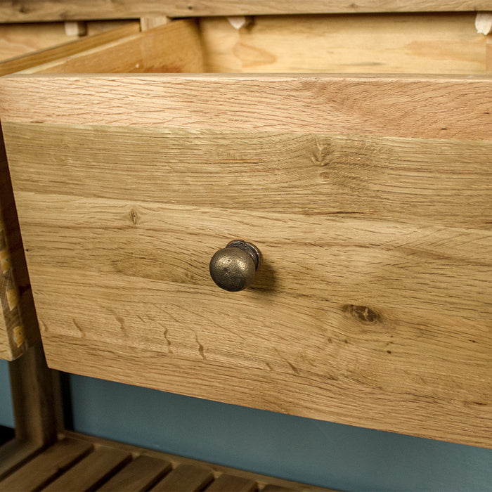 A close up of the brushed brass coloured handle on the drawer of the Farmhouse Hall Table.