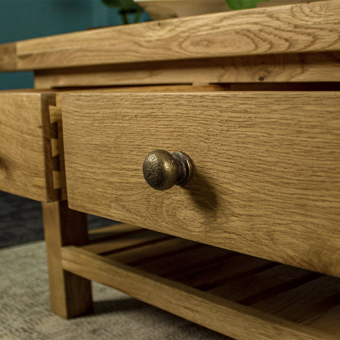 A close up of the brushed brass coloured metal handle on the Farmhouse Coffee Table.